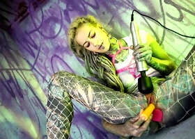 Anuskatzz dreads, pink harness, graffiti wall, she poses with the toy