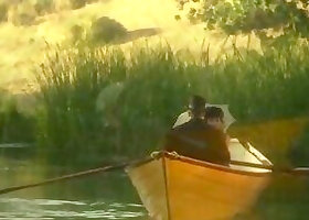 This lovely couple banged outdoors in the middle of a lake in a small boat