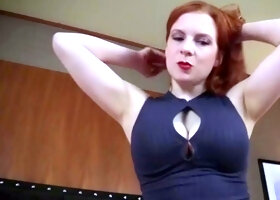 A red-haired girl in a ebony dress exerts femdom